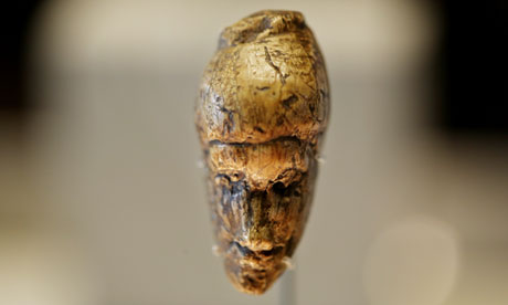 The oldest known portrait of a woman, sculpted from mammoth ivory during the last ice age around 26,000 years ago.  Photograph: Graeme Robertson for The Guardian. (Click on image to view larger.)